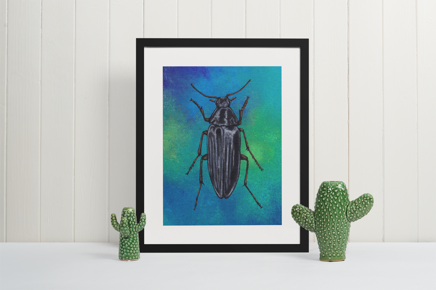 Mock Up of a Beetle (on a blue background) Art Print in a pine square frame. Artwork by Jenny Pond, JPArtwork