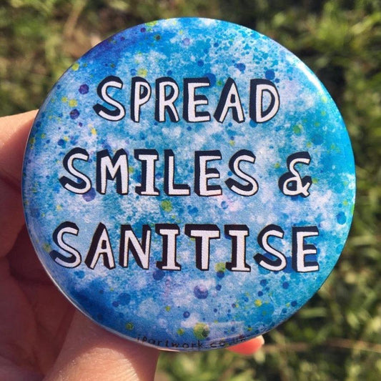 Large blue pin badge with the words SPREAD SMILES & SANITISE in bold 3D letters on. Ideal for keyworkers, nurses, and healthcare workers for promoting positive hygiene awareness. By Jenny Pond, JP Artwork